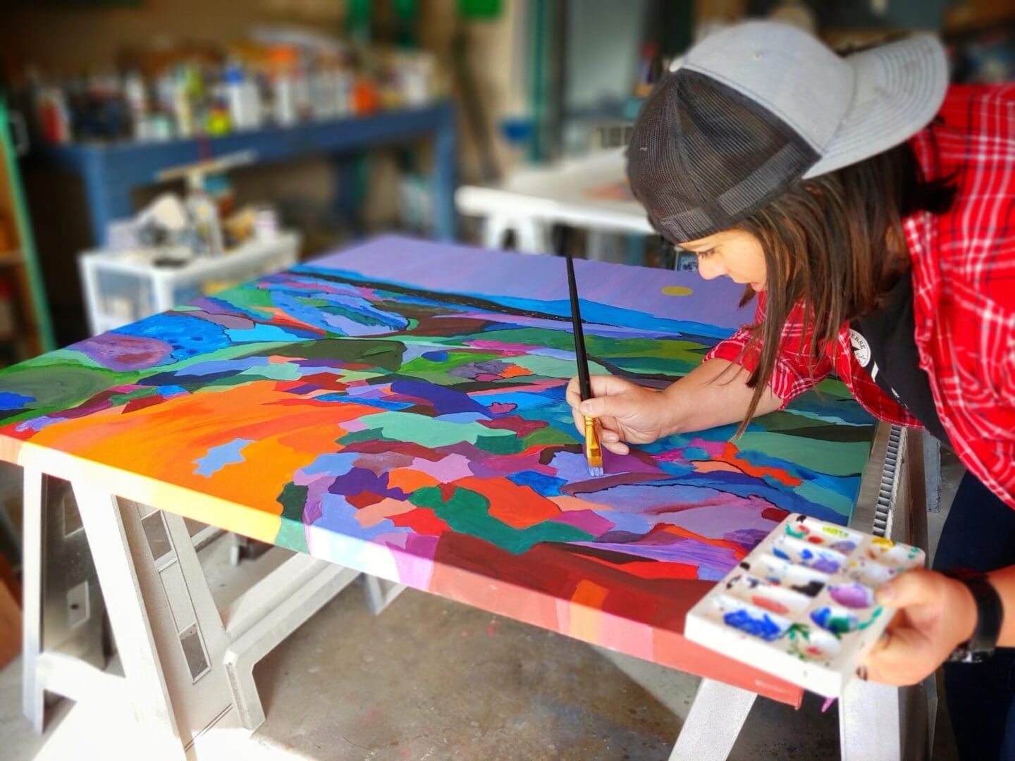 A person painting on top of a table.